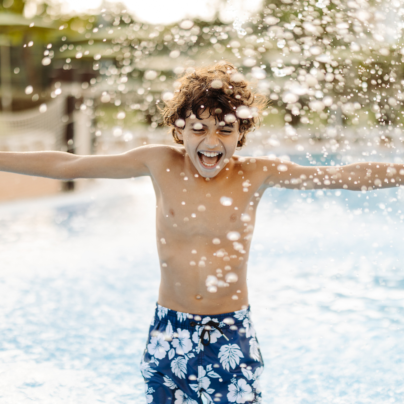 Child splashing in the pool
